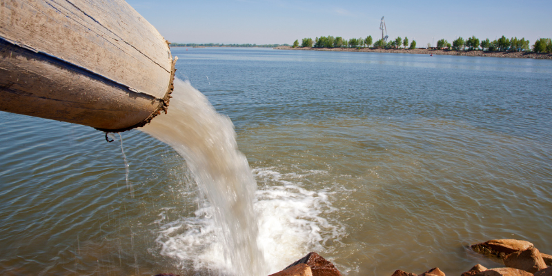 Pipe dumping residue on a lake